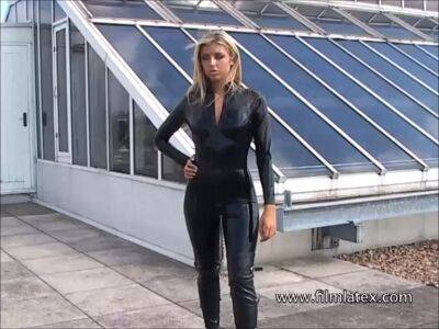 Karina - Blonde latex-babes outdoor knee boots and high heels of fetish girl in tight full body rubber outfit with softcore glamour model Karina outside on the roof - alphaporno.com