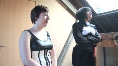 Dominant women in corsets and stockings discipline bare submissives in a rustic wooden dungeon - yesvids.com